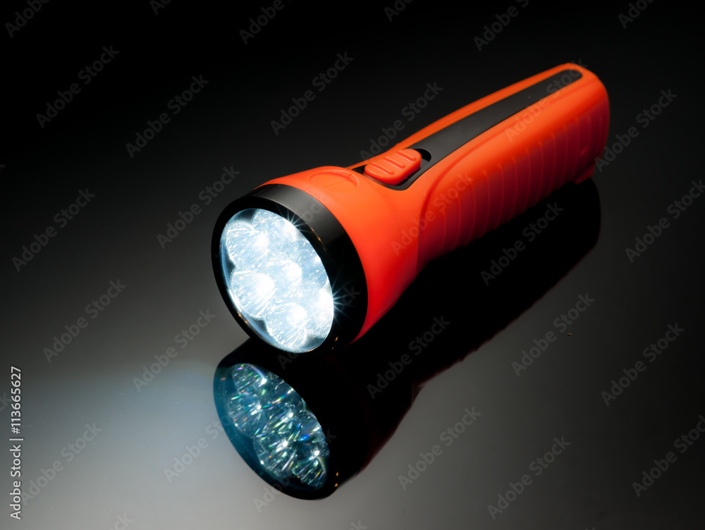 orange led lamps flashlight plastic body on reflected glass back orange led lamps flashlight plastic body on reflected glass back