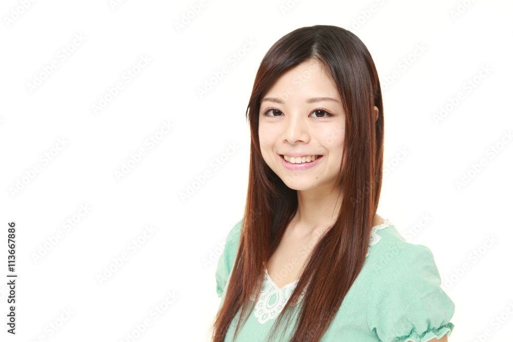 young Japanese woman wearing a green dress smiles young Japanese woman wearing a green dress smiles