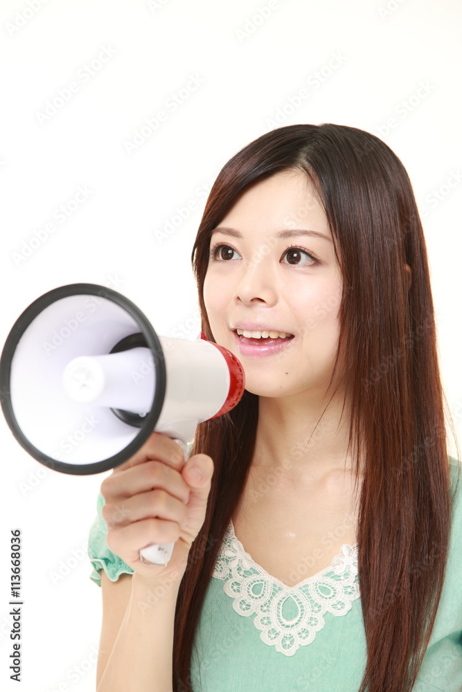 young Japanese woman wearing a green dress with megaphone