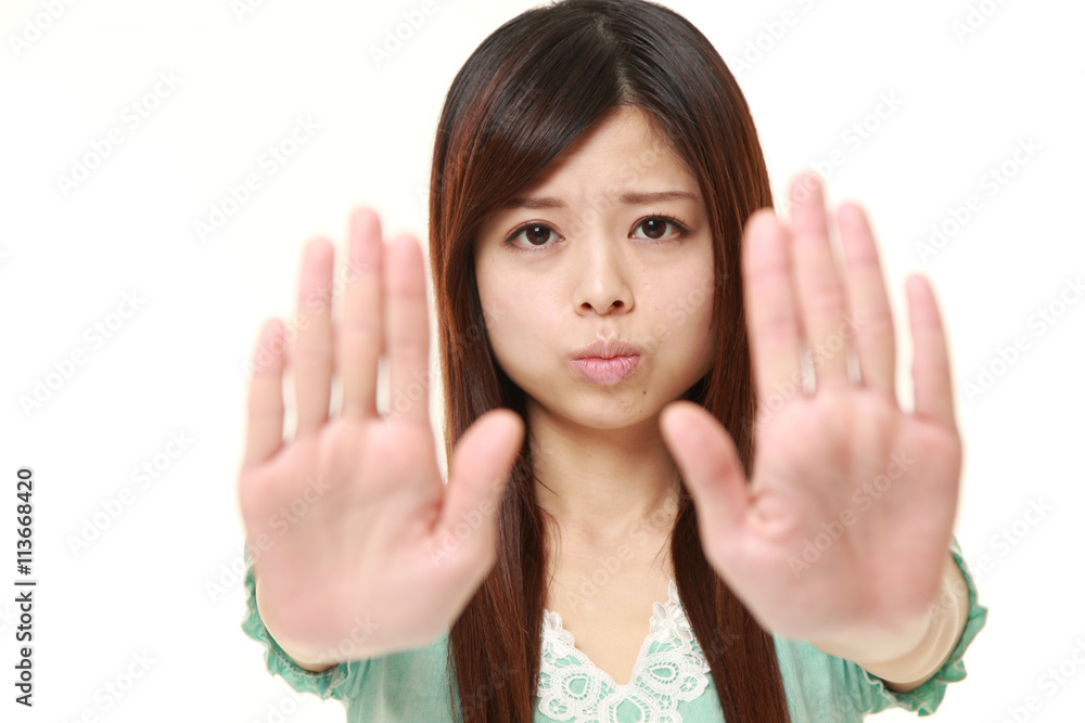 young Japanese woman wearing a green summer dress making stop gesture young Japanese woman wearing a green summer dress making stop gesture