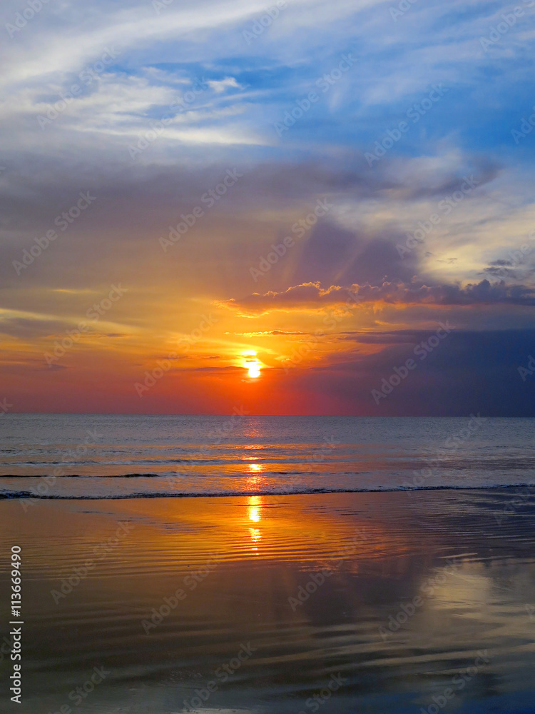 Beautiful sunset sky with reflection at Kuta beach, Bali
