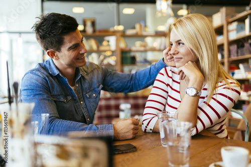 Beautiful couple in love flirting in cafe photo