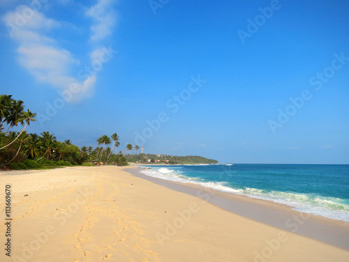 Fototapeta Naklejka Na Ścianę i Meble -  Empty clean beach with palms, Kamburugamuwa, Mirissa, Sri Lanka