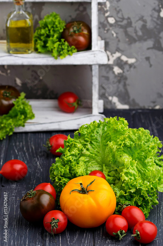 Colorful tomatoes on black background