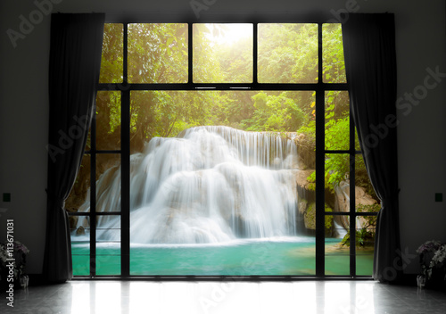 Silhouettes of window with a curtain, waterfall view background