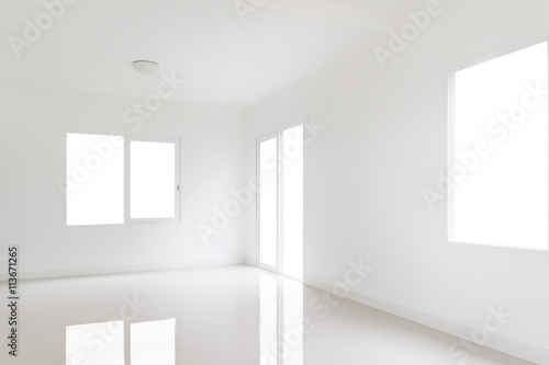 White room with a door and windows