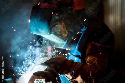 Worker welding in workshop photo