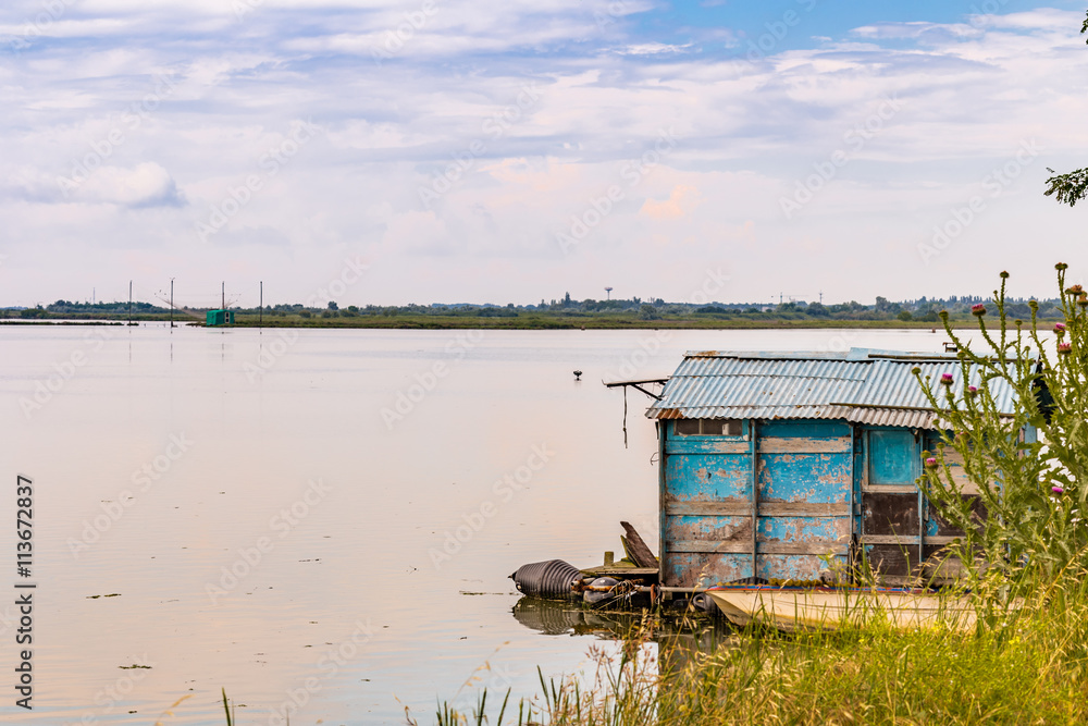 fishing hut in the quiet of brackish lagoon fishing hut in the quiet of brackish lagoon