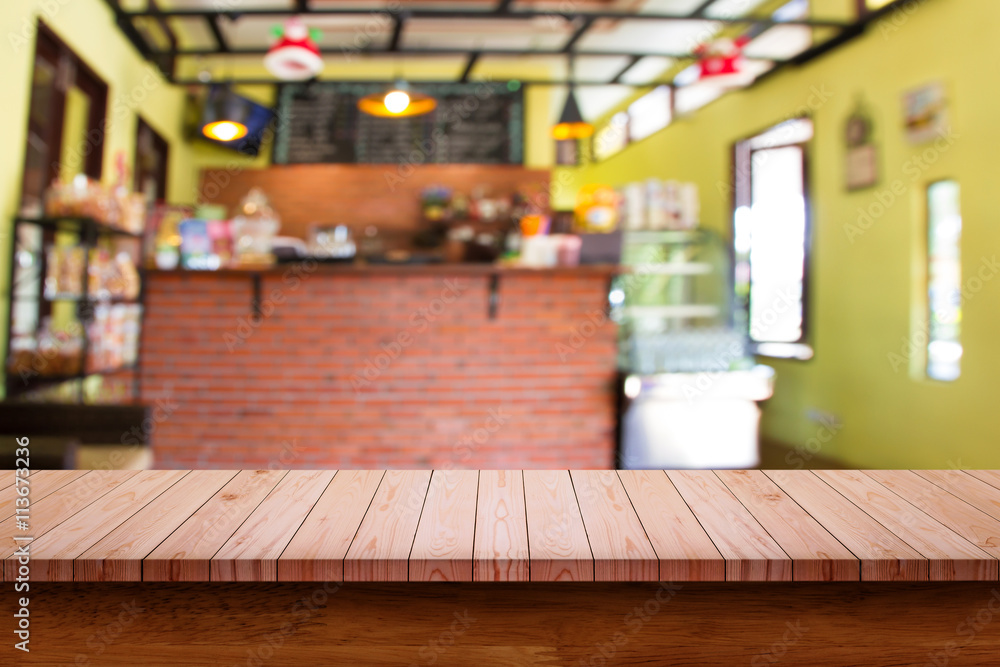 Empty top of wooden table with blur coffee shop background. Empty top of wooden table with blur coffee shop background.