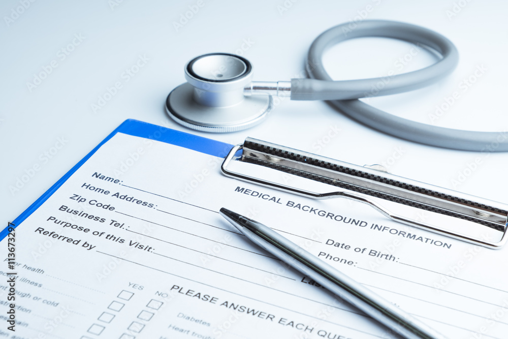 Patient information with pen and stethoscope white background Patient information with pen and stethoscope white background