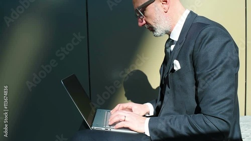 Middle age caucasian businessman using computer, wriitng down tapping on keyboard – business, technology, communication
 photo