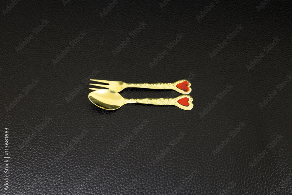Gold Spoon and Fork on dark background
Gold Spoon and Fork on dark background