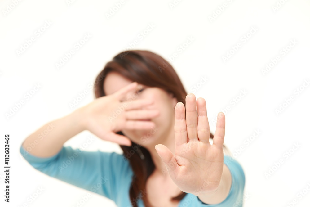 middle aged Japanese woman making stop gesture middle aged Japanese woman making stop gesture