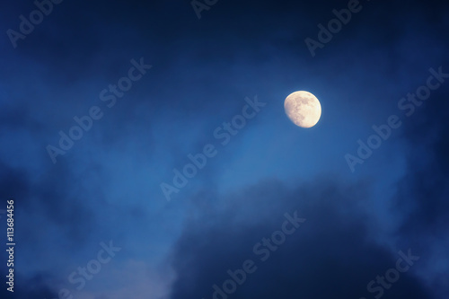 waxing gibbous moon on cloudy sky