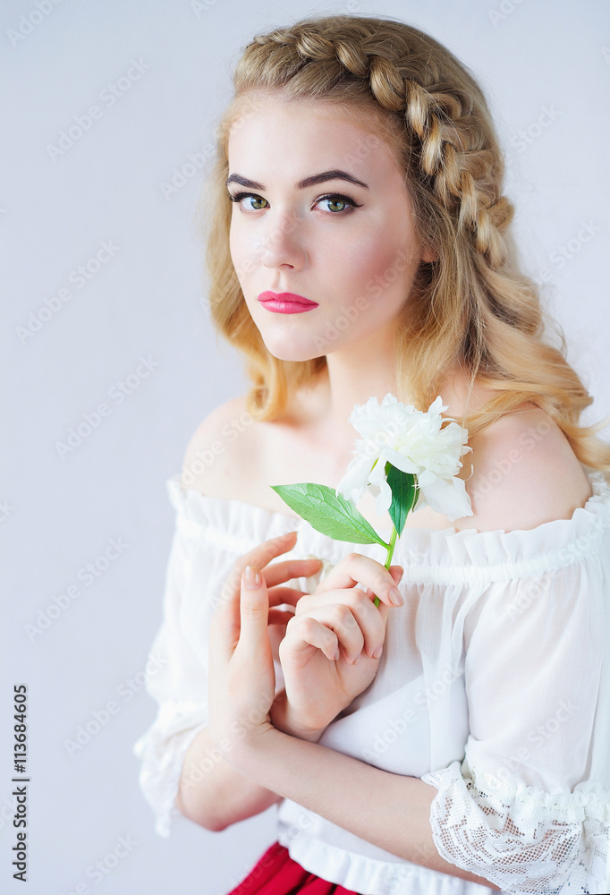 Beautiful woman portrait holding delicate white peony