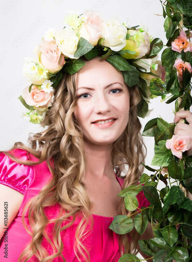 Beautiful young leggy blonde in a little red dress on head wreath of flowers, rope wrapped vine and ivy Beautiful young leggy blonde in a little red dress on head wreath of flowers, rope wrapped vine and ivy