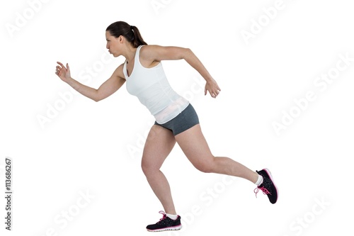 Side view of energetic female athlete running