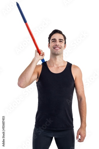 Happy male athlete holding javelin