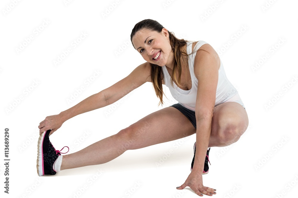 Happy athlete woman stretching her hamstring