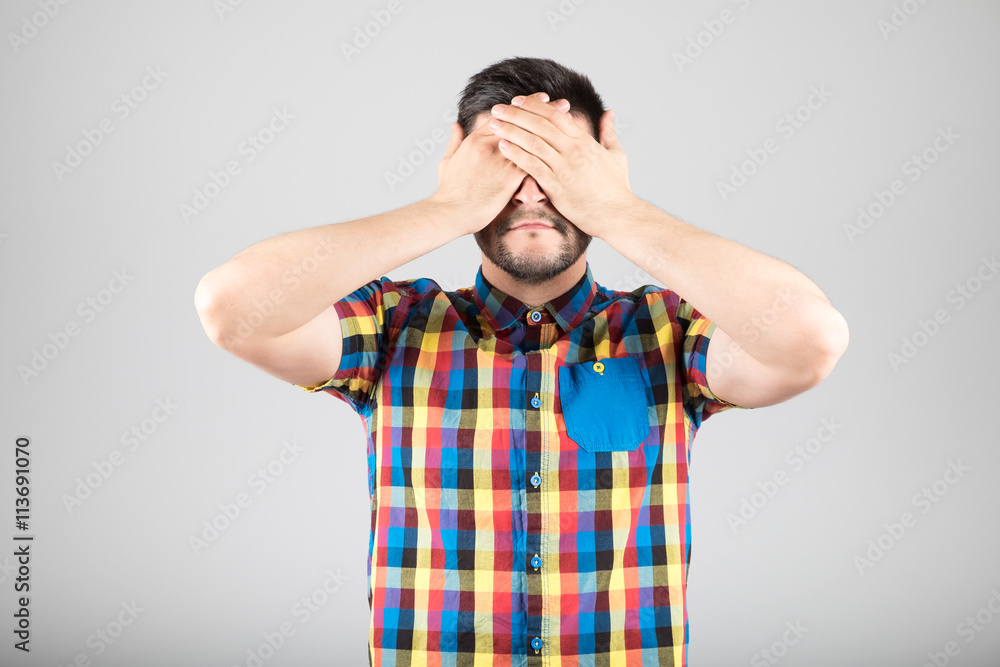 Man covering his eyes Man covering his eyes