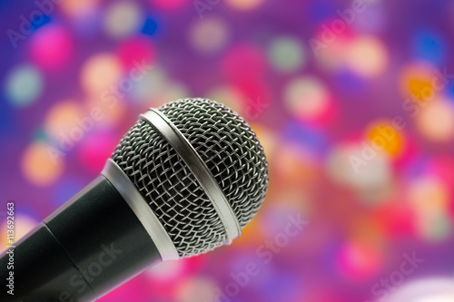 Close-up of a grey microphone in concert hall on abstract blurred background