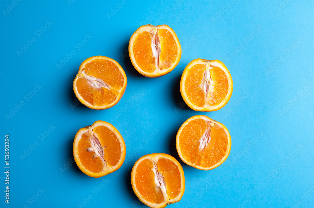 Cut oranges from above on blue background Cut oranges from above on blue background