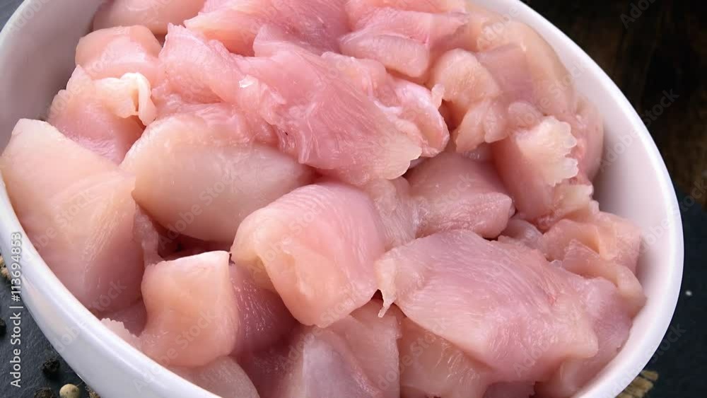 Rotating raw Chicken Fillet (chopped) as not loopable 4K footage Rotating raw Chicken Fillet (chopped) as not loopable 4K footage