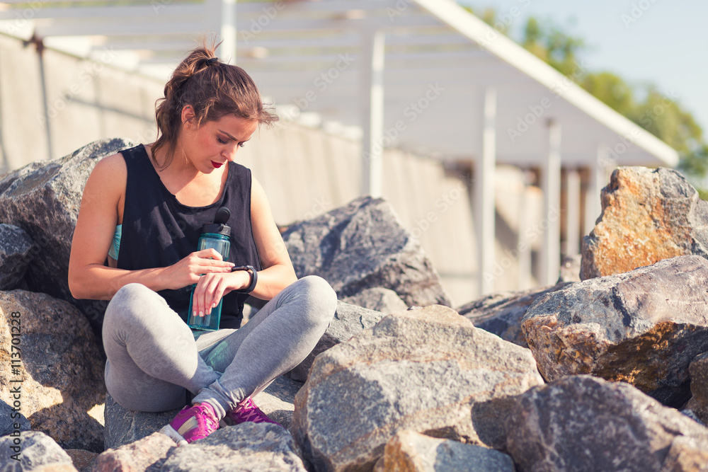 Woman resting after training outside at the beach Woman resting after training outside at the beach