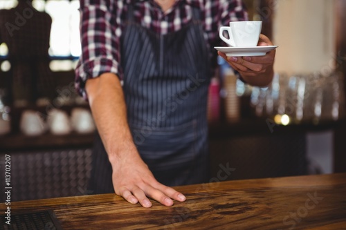 Waiter handing over a coffee