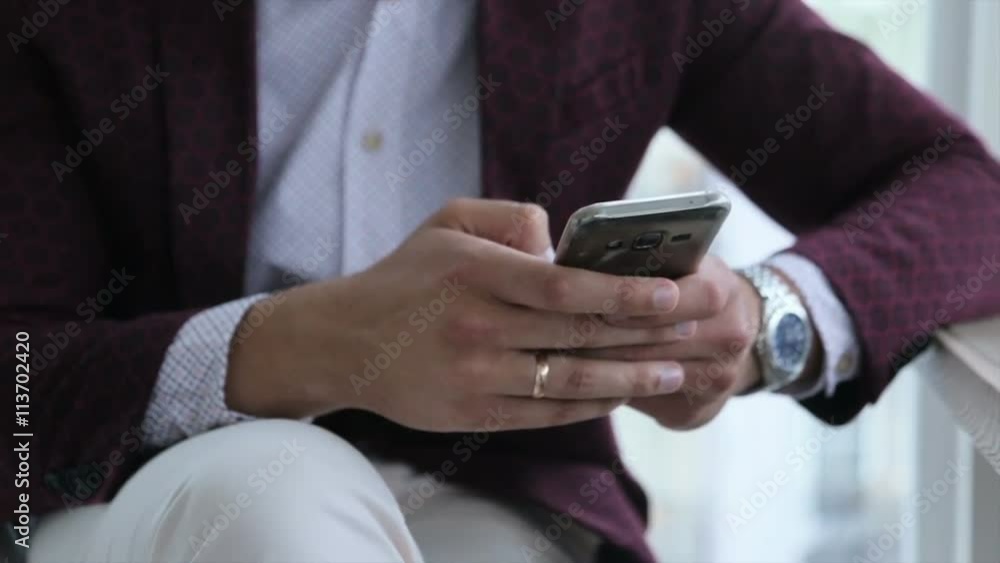 Happy businessman with mobile telephone or smartphone, visiting web site and browsing the internet near office building. People, manager, technology, smartphone Happy businessman with mobile telephone or smartphone, visiting web site and browsing the internet near office building. People, manager, technology, smartphone