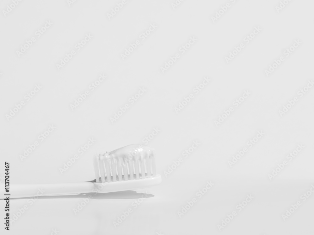 Grayscale tone of toothbrush with toothpaste and background