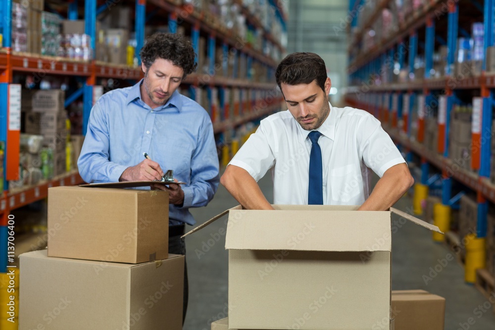 Managers are checking some cardboard boxes Managers are checking some cardboard boxes