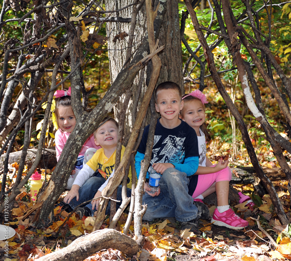 Four children sit inside their secret