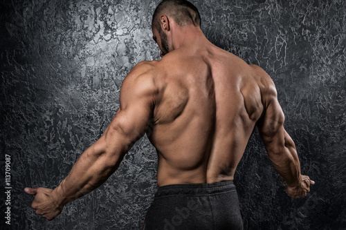 Fototapeta Man showing his muscular back