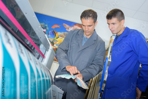 Fotografie Two men checking the color of printed matter