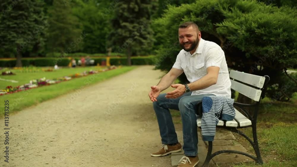 Father plays with little son, sitting on a bench at the park
Father plays with little son, sitting on a bench at the park