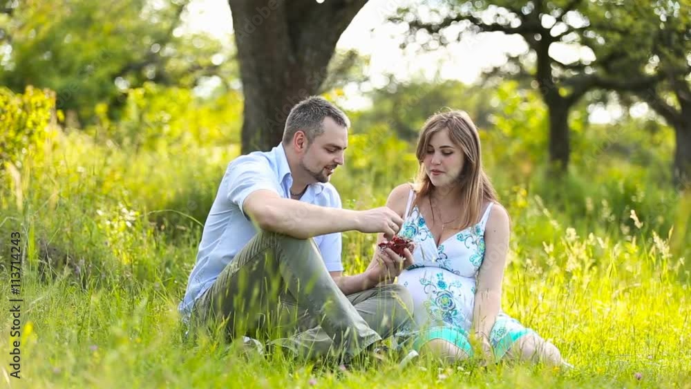 Pregnant happy couple eating strawberries Pregnant happy couple eating strawberries
