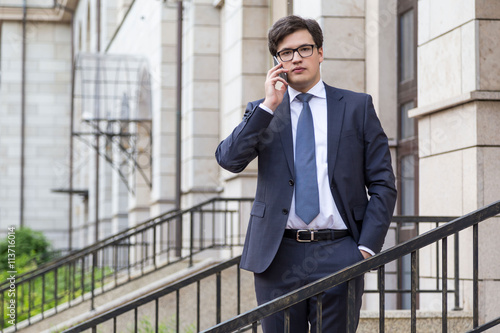 Young attractive businessman on phone