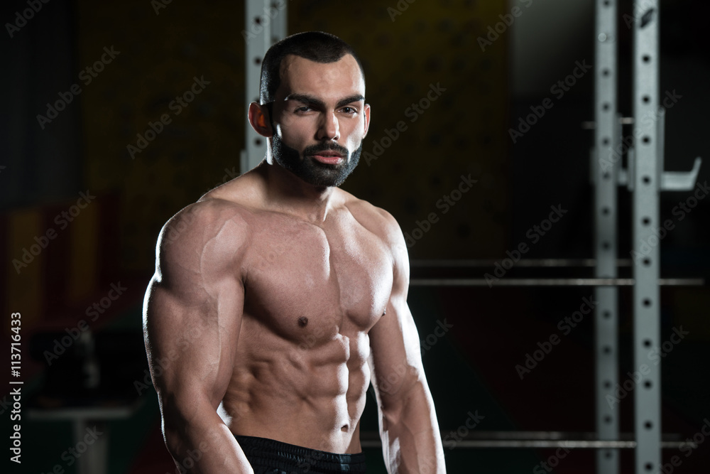 Healthy Young Man Flexing Muscles