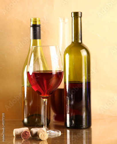 wine bottle and wine glass on a glass table