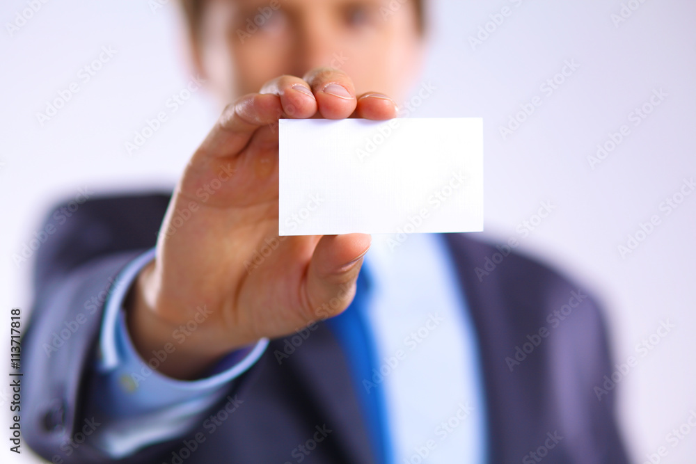 young businessman holds out his hand with a business card for love young businessman holds out his hand with a business card for love