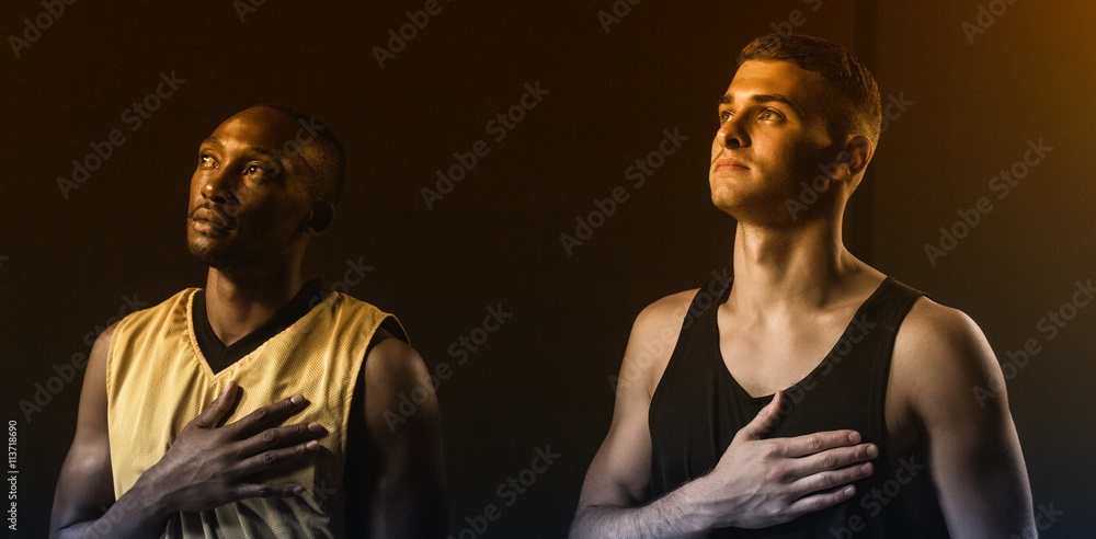 Portrait of basketball players putting hand on heart Portrait of basketball players putting hand on heart