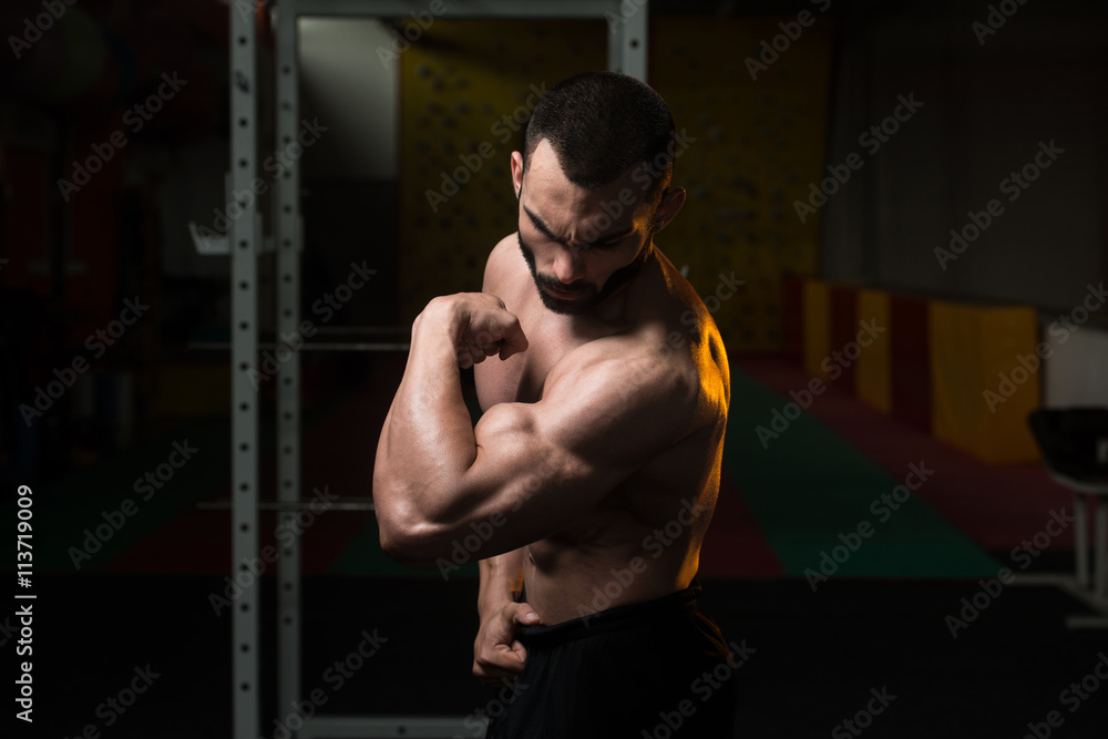 Young Bodybuilder Flexing Muscles Biceps Pose