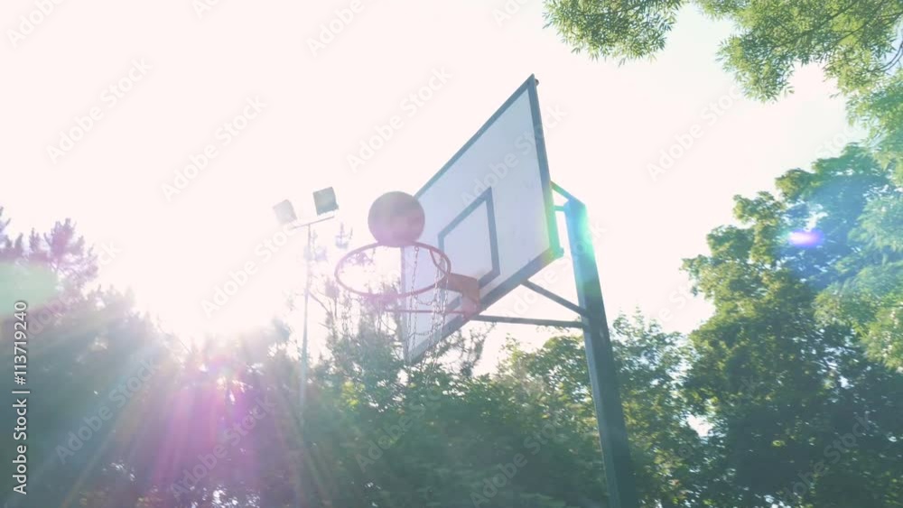 Young muscular man playing basketball in the park Young muscular man playing basketball in the park