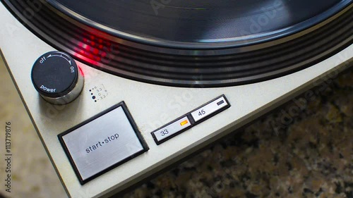 Stop turntable of the plate at 33 rpm. Stroboscope correct disk speed checks photo