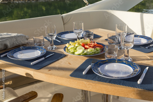 breakfast on yacht, dinning table on the upper deck in luxurious yacht
