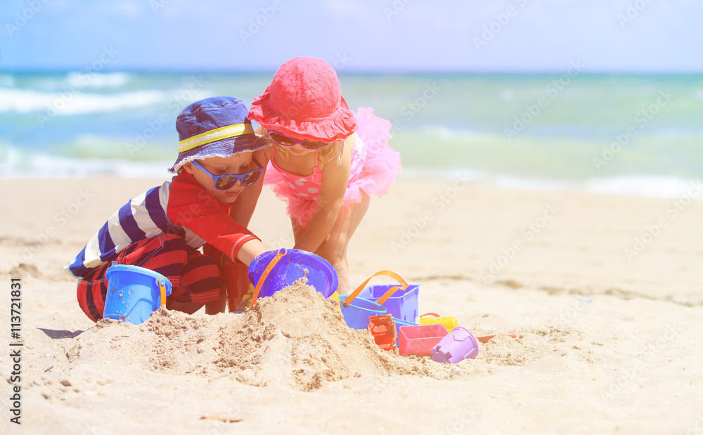 kids play with sand on summer beach kids play with sand on summer beach