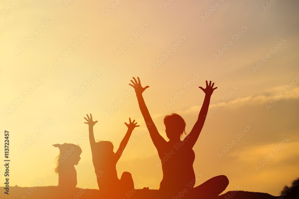 Silhouette of happy mother and kids at sunset Silhouette of happy mother and kids at sunset