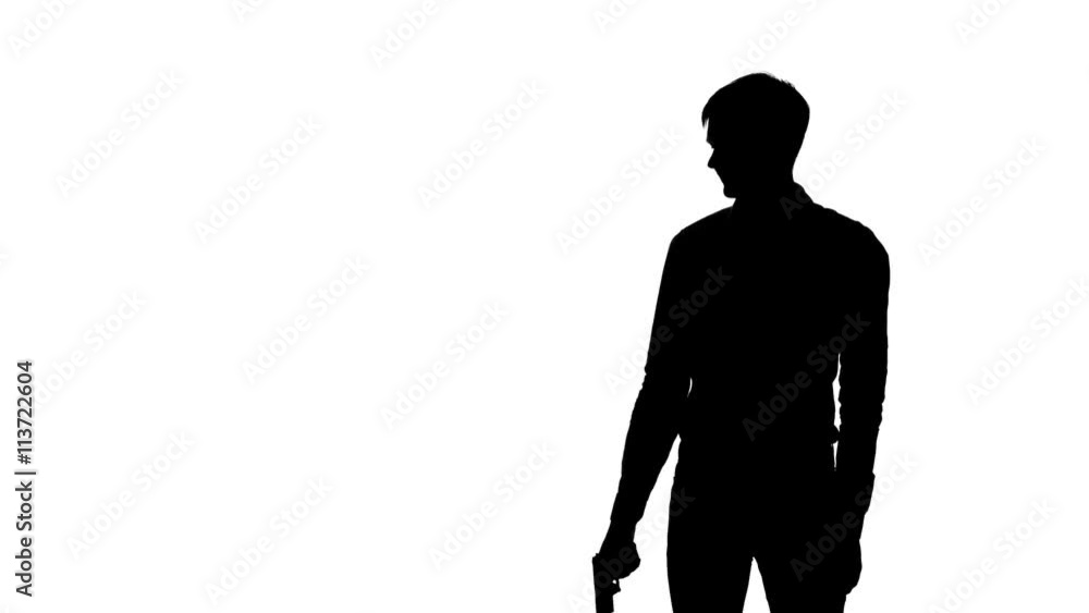 Man raises the gun and blows the barrel. Silhouette. White Man raises the gun and blows the barrel. Silhouette. White