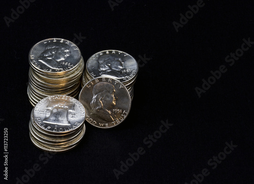 Stacks of Ben Franklin half dollar silver coins photo